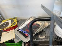 Saw blades and paint tray kit on shelving