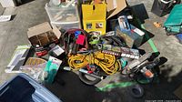 Overall view of tools, extension cord, spotlight box, jigsaw, sanders