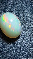 Top view of oval Ethiopian fire opal showing multicolor play-of-color