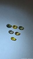 Six mixed-colour oval sapphires on neutral background