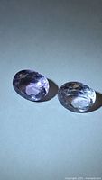 Both amethyst gemstones side by side to show matching cut and color