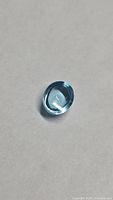 Front view of oval cabochon Swiss blue topaz