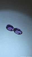 Pair of oval purple amethysts side by side