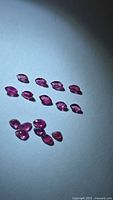 Group of loose marquise rubies under angled light