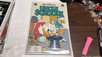 Front cover of bagged Uncle Scrooge #299 comic on tabletop