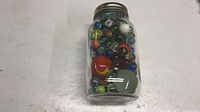 Front view of jar showing assortment of marbles
