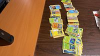 Wide view of two table rows piled with loose Pokémon cards