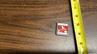 Front of Nintendogs Nintendo DS cartridge with red label and measurement