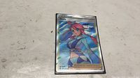 Front view of Skyla full-art holo card in sleeve