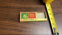 Front of Swan Vestas matchbox beside tape measure