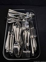 Top view of tray showing various knives, forks and spoons