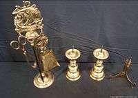 Full lot showing tool stand with tools, two candlesticks and trivet