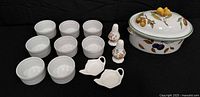 Group shot showing casserole dish, lid, eight ramekins, two shakers, two mini dishes