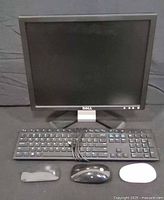 Front view of Dell monitor, keyboard and three mice