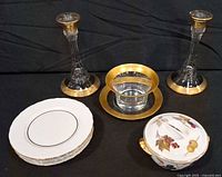 Group view of candlesticks, bowl with underplate, dessert plates and sugar bowl