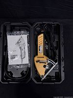 Saw, manual, dust hose inside open case