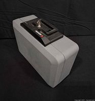 Angled view of gray Sentry lock box showing handle and overall exterior