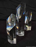 Three clear quartz prisms standing upright