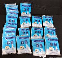 All sealed Tide & Downy Free & Gentle promotional packs arranged on black background