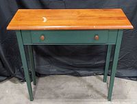 Front view of two-tone console table showing overall design and drawer