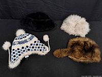 Group shot of four winter hats showing styles and colors