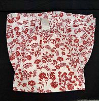 Red and white floral smocked top folded