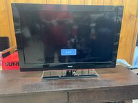 Front view of RCA 32" TV powered on showing "No Signal"