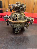 Front view showing carved details, handles, feet, and lid