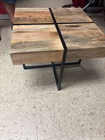 Top view showing four wooden blocks separated by black metal strips