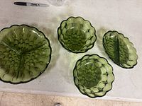 Top view showing all four green pressed glass pieces