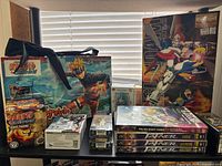 Overall view of all items on shelf including MG Gundam kit, Naruto items, DVDs, mini figure boxes