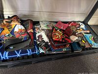 Shelf with multiple rolled playmats and cloth items