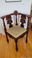 Full view of carved mahogany corner armchair