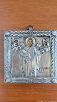 Full view of square silver-covered icon with Saint Nicholas