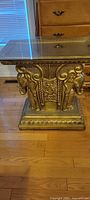 Full view of gold elephant pedestal base with glass top in place