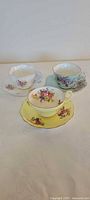 Overview of three teacup and saucer sets