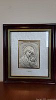 Full framed sterling silver Madonna picture on table