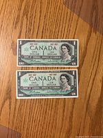 Fronts of two 1967 Canada $1 Centennial banknotes