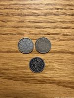 Reverse sides of three Canadian 10 cent coins