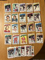Fronts of 25 cards laid out plus partial stack showing various teams and players