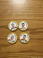 Front view of four Boston Bruins player coins showing portraits and names