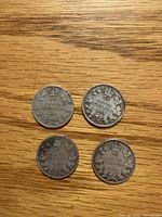 Obverse view of four Edward VII Canadian 10¢ coins dated 1904-1907