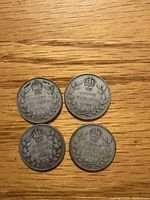 Reverse sides showing 10 Cents Canada wreath design and dates 1931, 1933, 1934, 1935