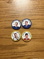 Front view of all four NHL plastic coins showing player images and details