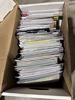 Top-down view of box showing large stack of bagged and boarded comics