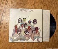 Front cover of Rolling Stones Metamorphosis vinyl album with record partially exposed