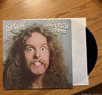 Front cover of Ted Nugent Cat Scratch Fever album with vinyl partially in sleeve