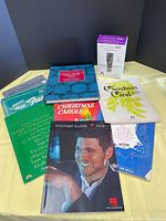 Lot overview showing microphone box and all songbooks spread on yellow surface