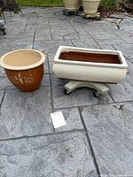 Both planters with stand on casters displayed on patio