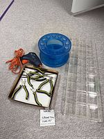 Group shot showing glue gun, pliers in box, blue rotating holder, clear acrylic tray